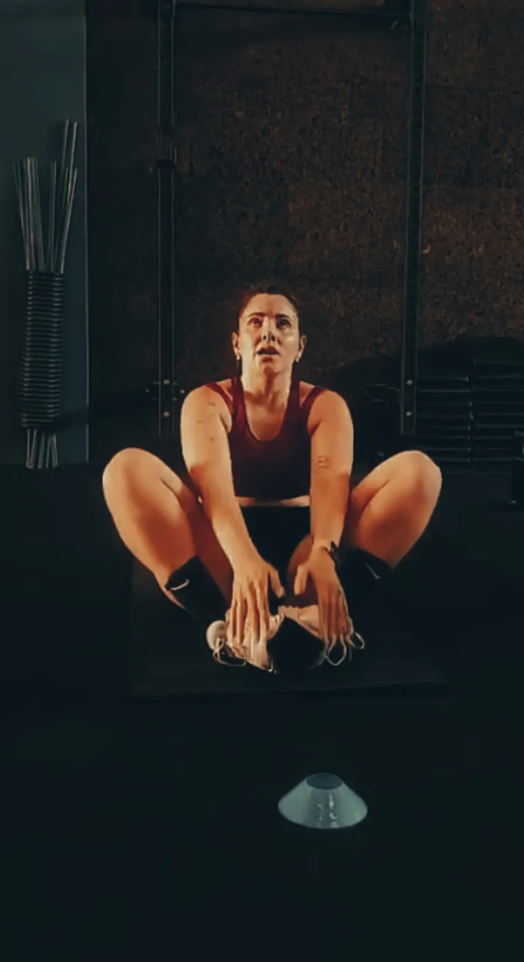 Atleta sentada no chão a alongar depois do treino